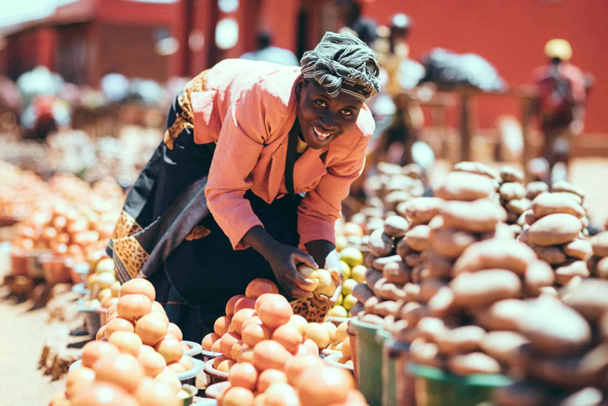 Woman smiling over her produce in the market