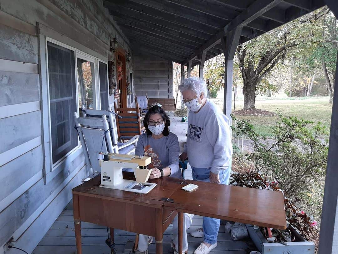 Melissa sews with her grandmother outside following COVID protocols.