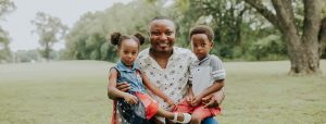 Volunteer with two children