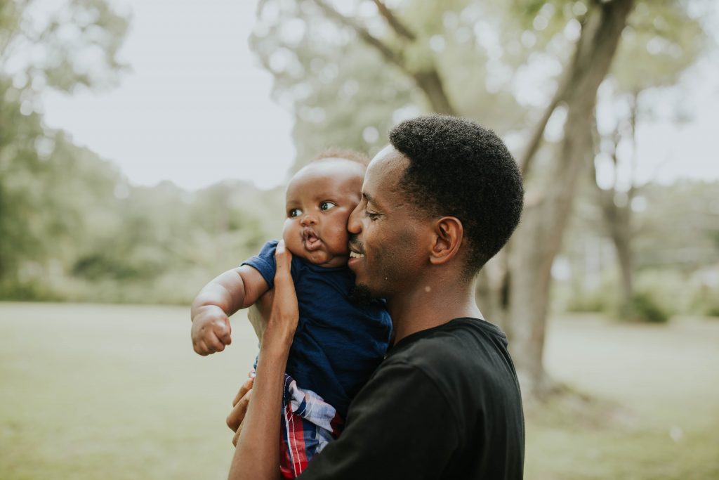 A man kisses his son.