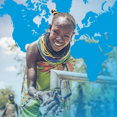 Young girl pumping water and smiling in Forward Together Background