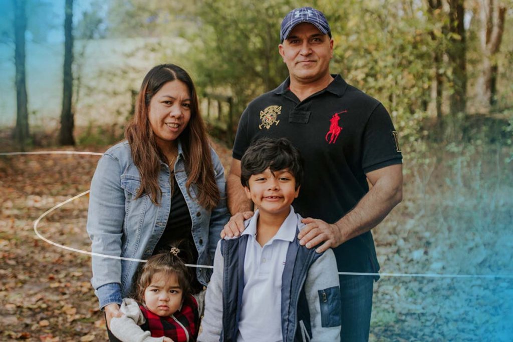 Refugee family smiling with World Relief design element