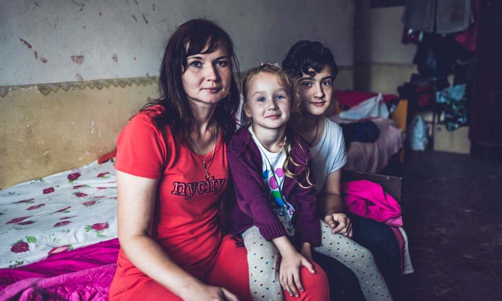 A mother with her children who had to flee their home in Western Ukraine after Russian forces advanced to their city.
