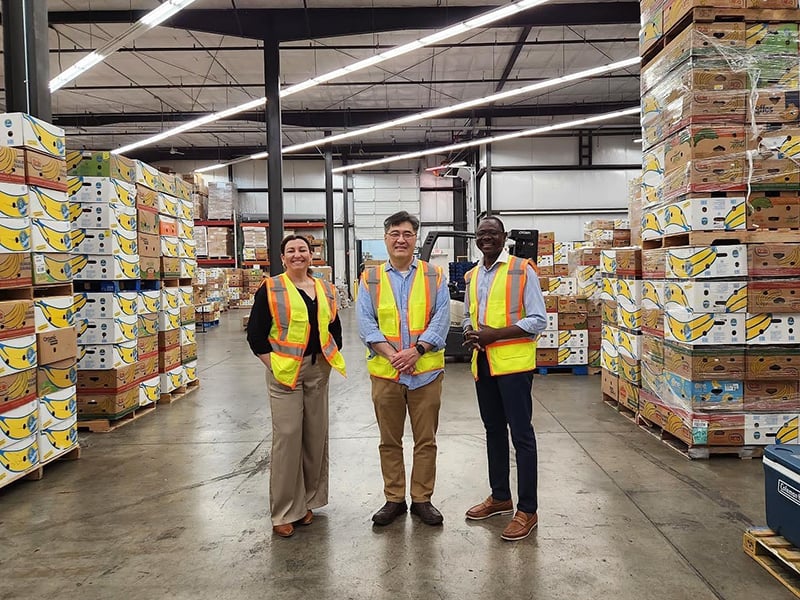 Picture of Medard, Natlaie Teabo and Jay Kang at the Thurston County Food Bank.