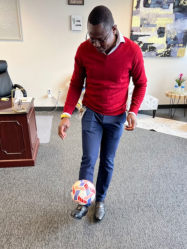 Medard playing soccer in local World Relief office