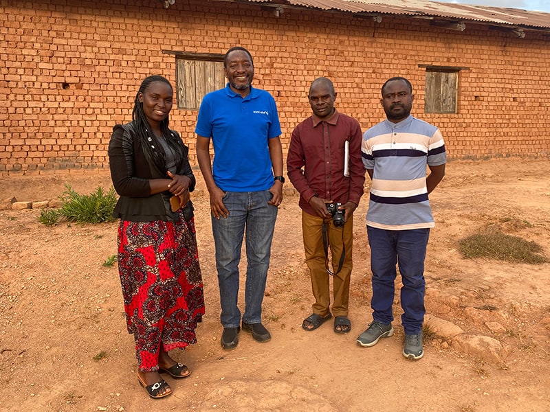 Dennis, in blue, meets with World Relief staff in Malawi.