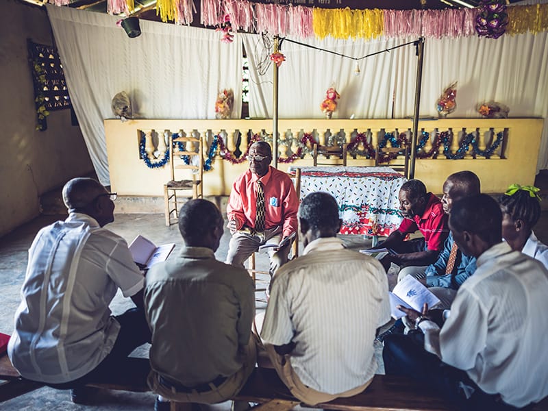 Pastors sit in a church small group setting in Haiti.