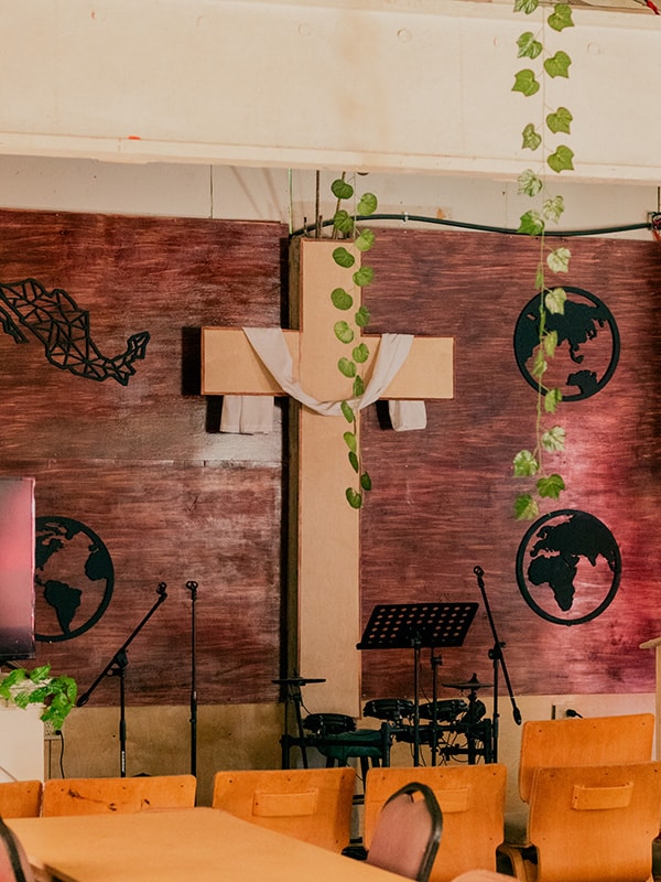 image of a wooden cross at the front of a church sanctuary