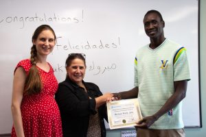 Morella shakes hands with a client.