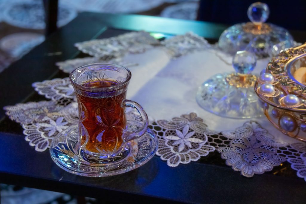 Afghan tea with cardamom in a crystal glass. Refugee like to share their culture with Americans.