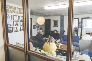 Mely talks to clients in the Friendship Center
