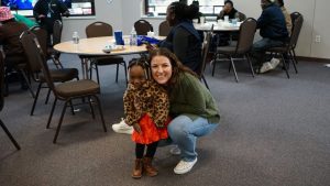 A woman with a kid at a christmas party