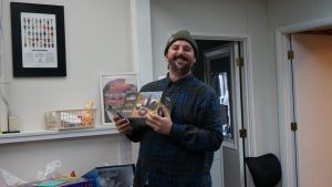 An intern holding his birthday gift.