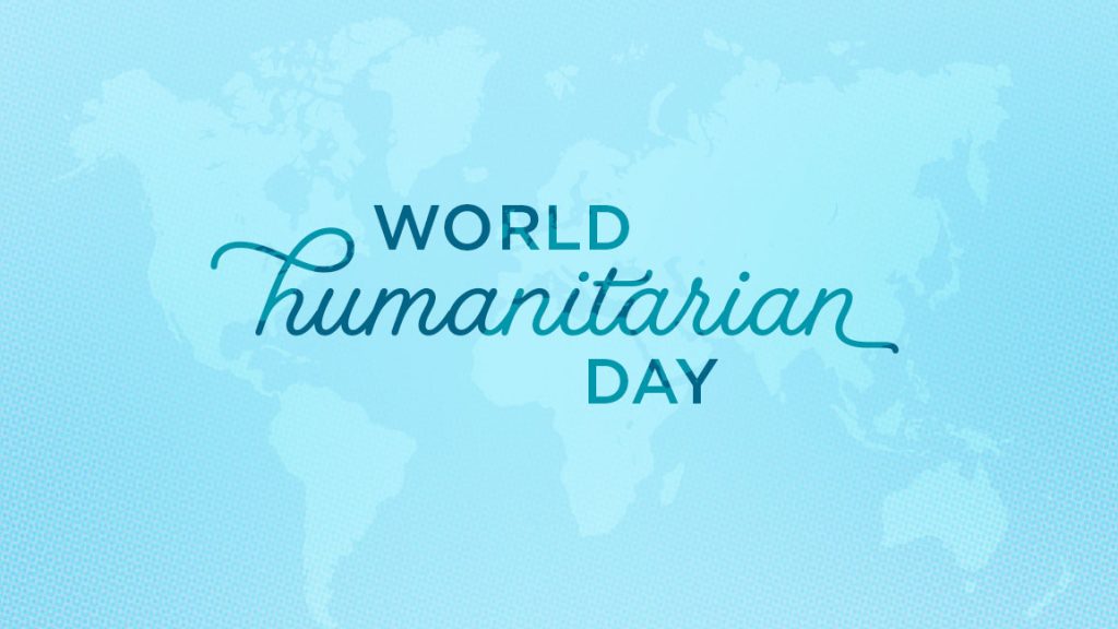 World Humanitarian Day written in script on a light blue map background