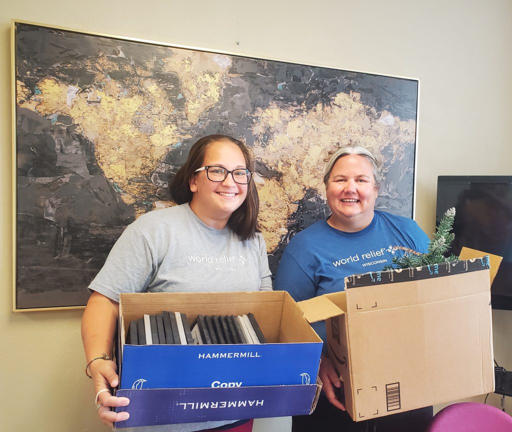 World Relief Wisconsin staff move boxes to new Oshkosh office.