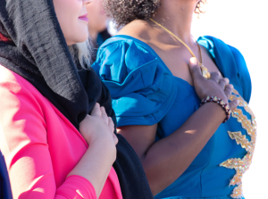 Two women saying the pledge of allegiance at an oath ceremony - let freedom ring