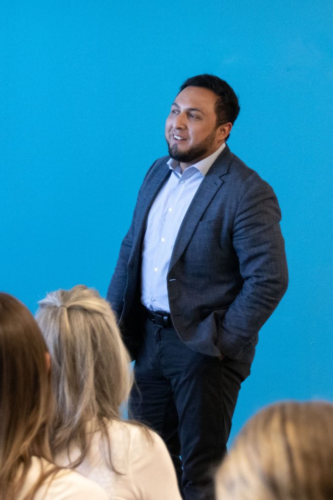 Joel Arriaga smiles while giving a speech.