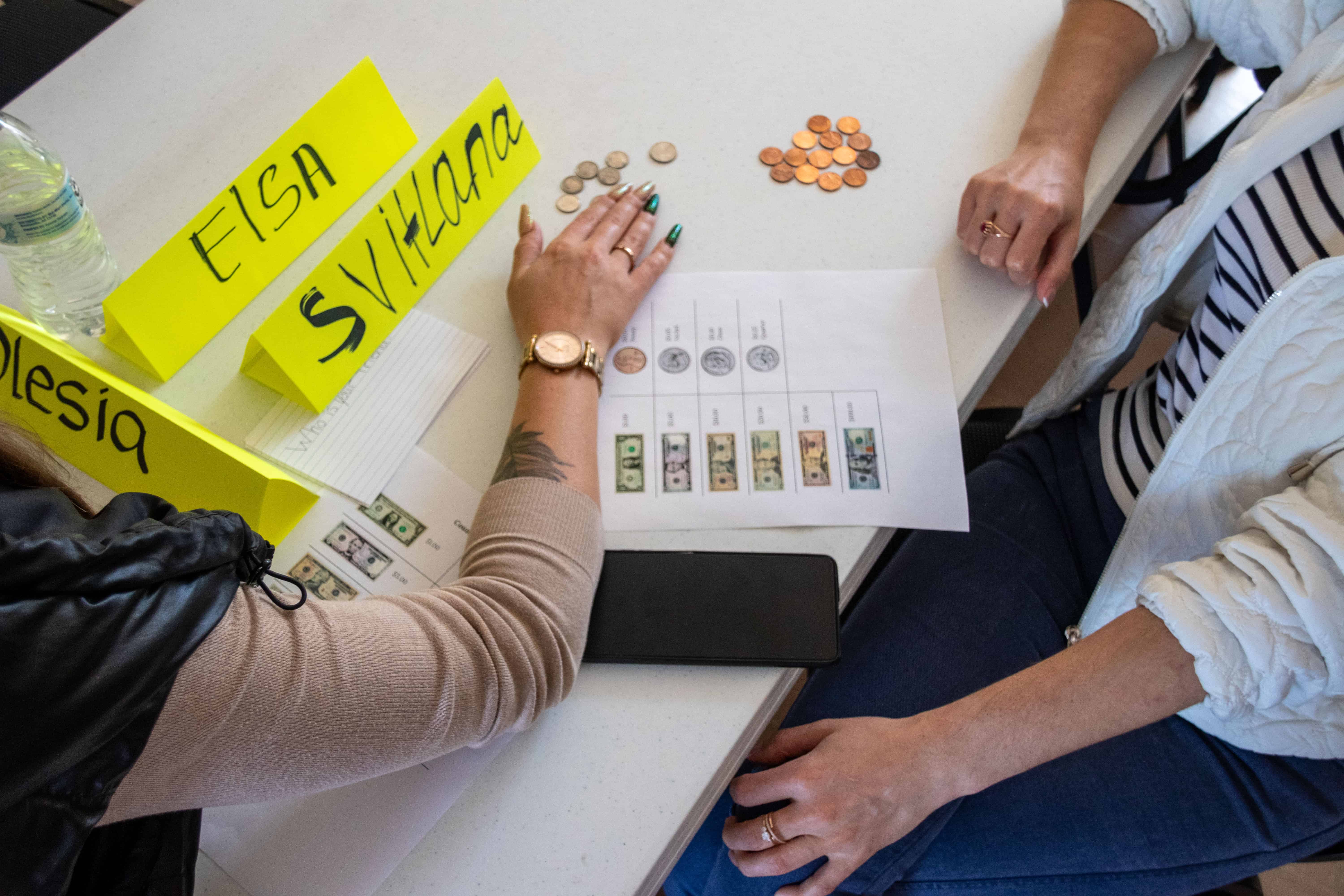 English Conversation Club participants counting money