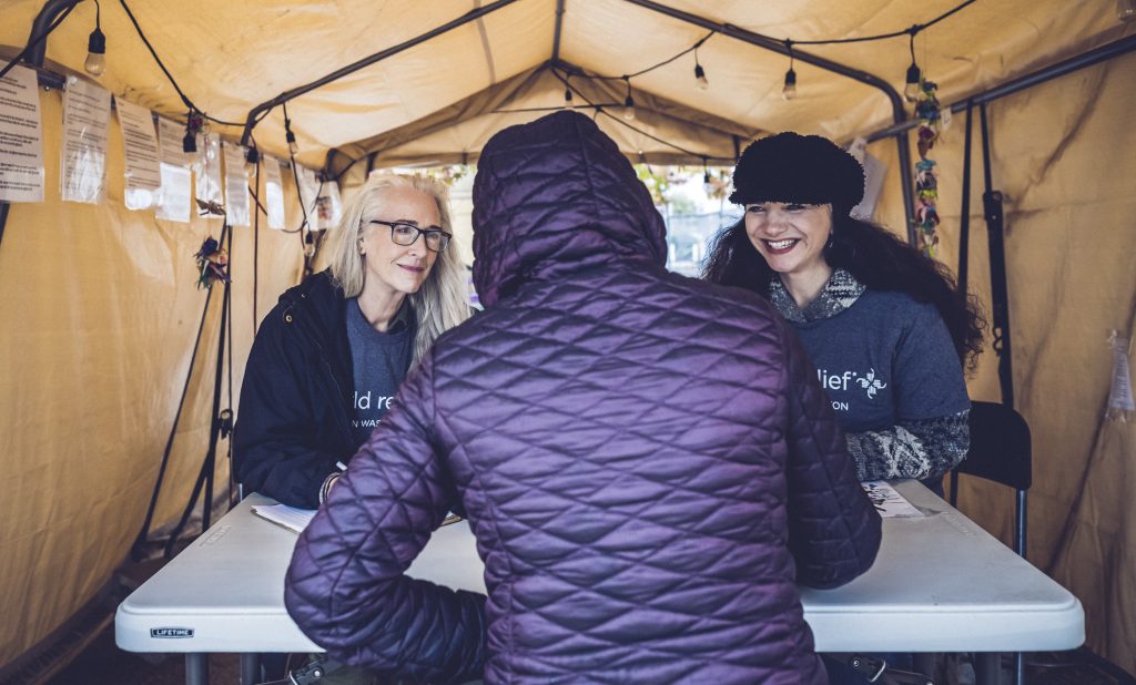 World Relief, Tacoma and Federal Way, WA, October 21, 2022. This is at the Tacoma dentention center where they have the bus for refugees that are released from holding. Sean Sheridan Photographs.