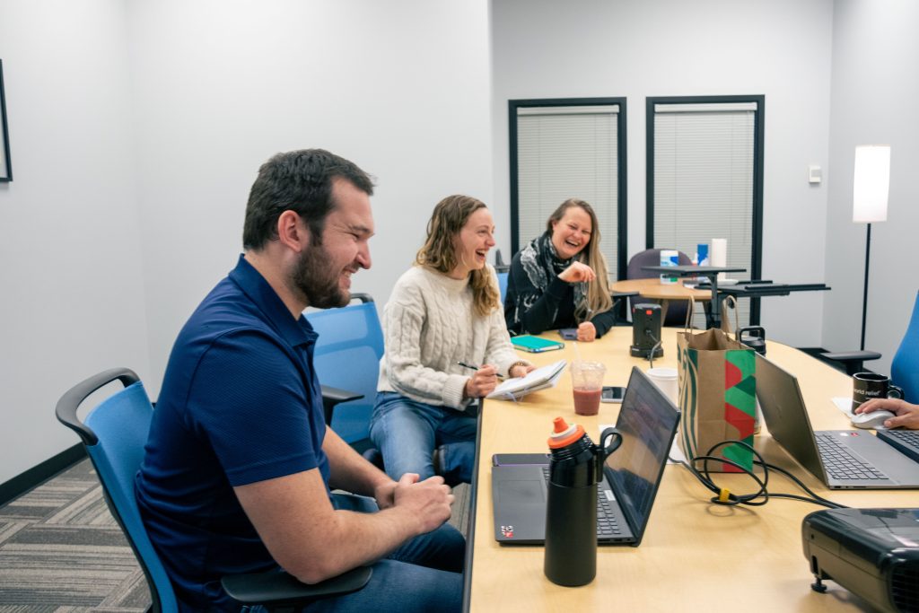 Resettlement case managers laughing at a meeting.