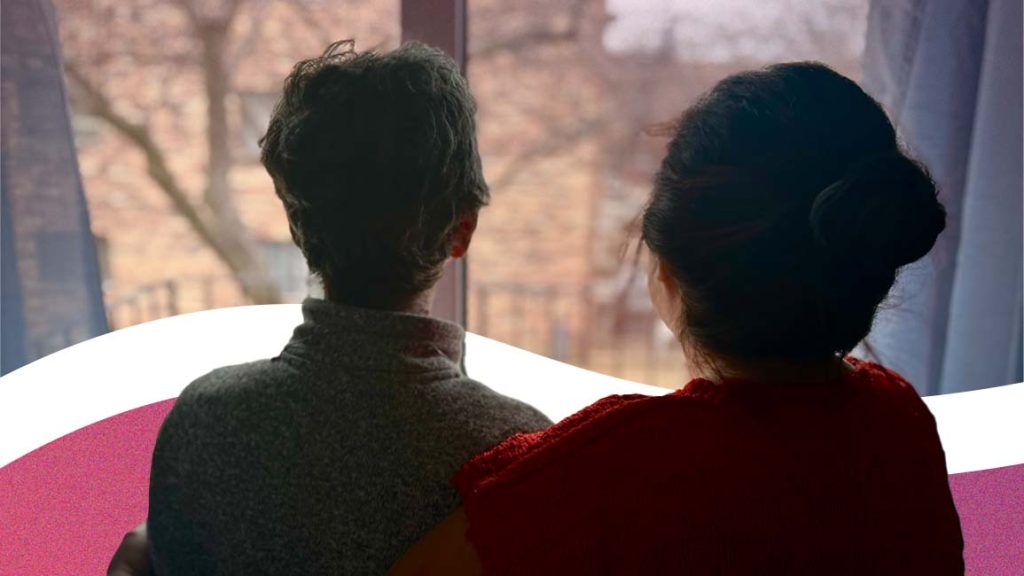 Refugee journey: Two people look out of a window.