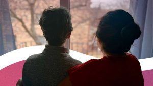 Refugee journey: Two people look out of a window.