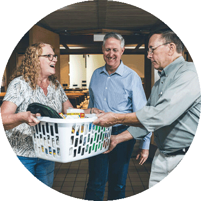 gift-guide-church-community-church-partner two people holding a basket of gifts