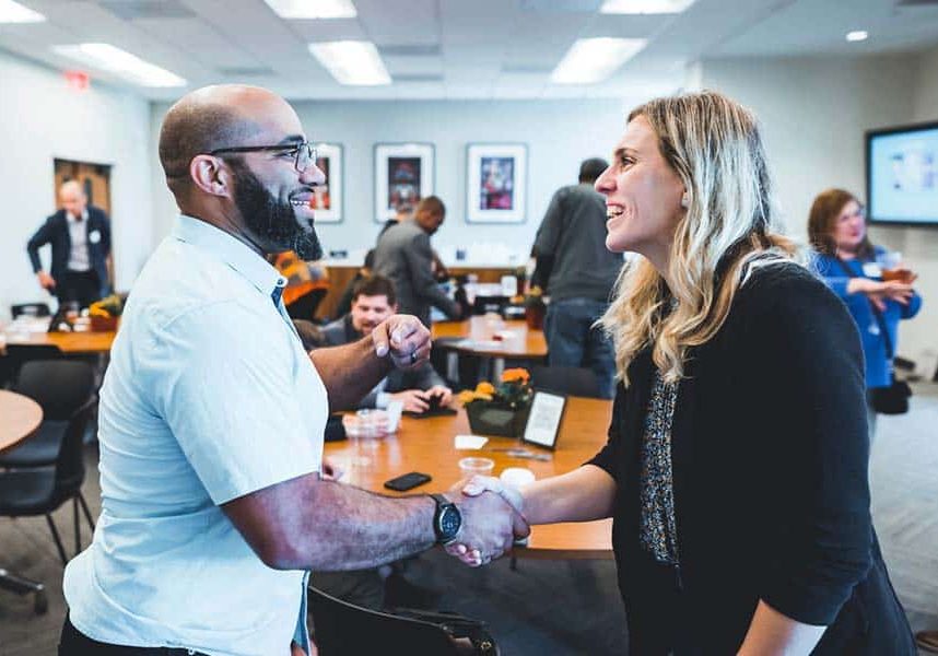 World Relief staff shaking hands with an advocacy event participant