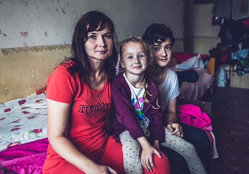 A mother with her children who had to flee their home in Western Ukraine after Russian forces advanced to their city.