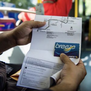 Person holding a bus pass