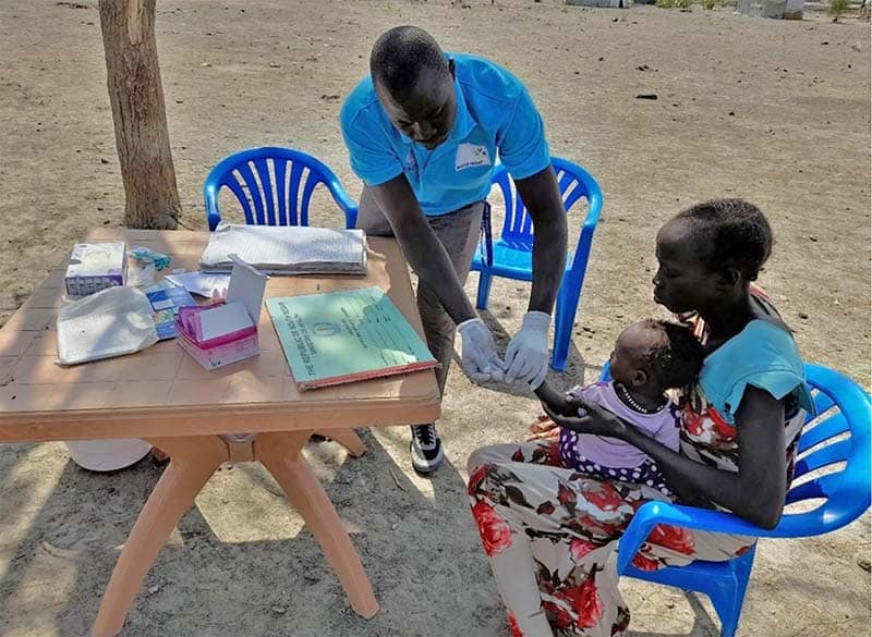 A World Relief health worker treats Nyawaraga's child. Creation care is an important way we can help families like hers.