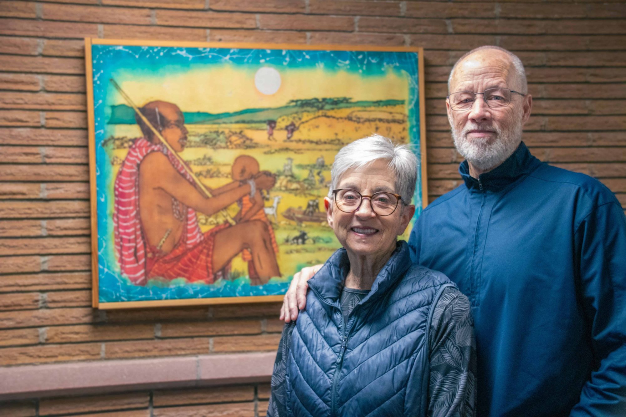 The Dorways, who stand in front of a picture of Africa, volunteer at World Relief.