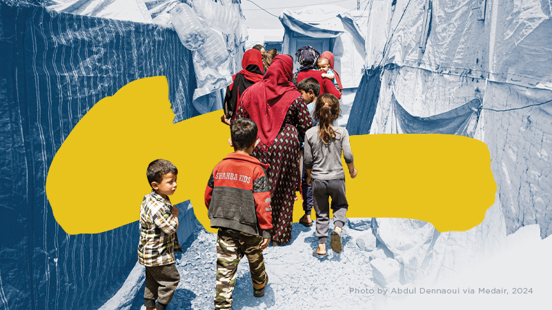 World Relief 2024 Annual Report: A group of refugees including children walk through an informal settlement in Lebanon.