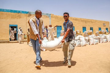 An icon depicting a box topped with books and a uniform.