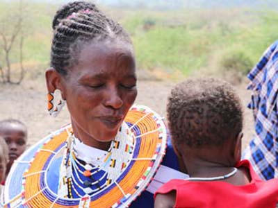 Woman holding and looking at an infant