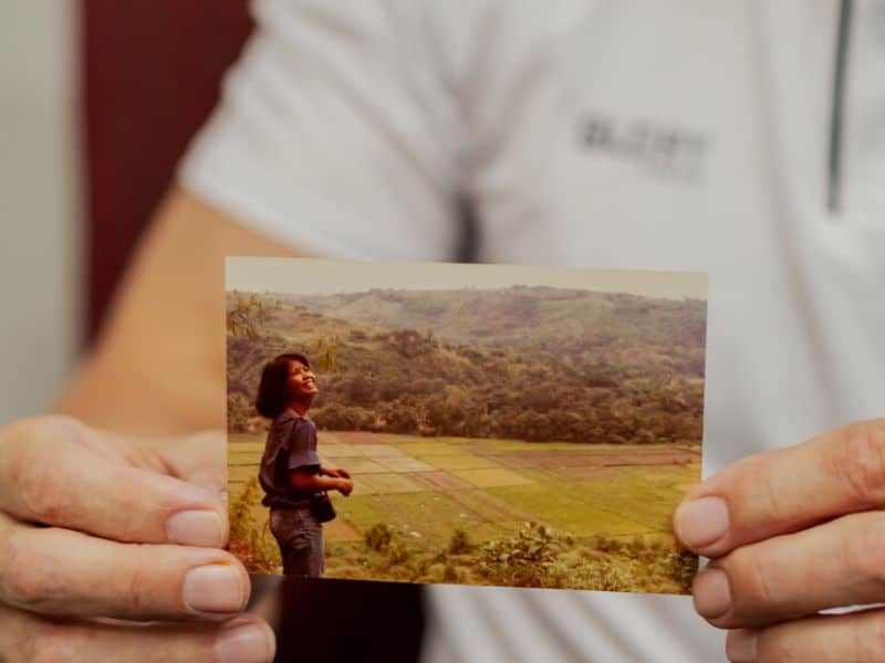 Mark Hull holding photo of wife, Marcel.