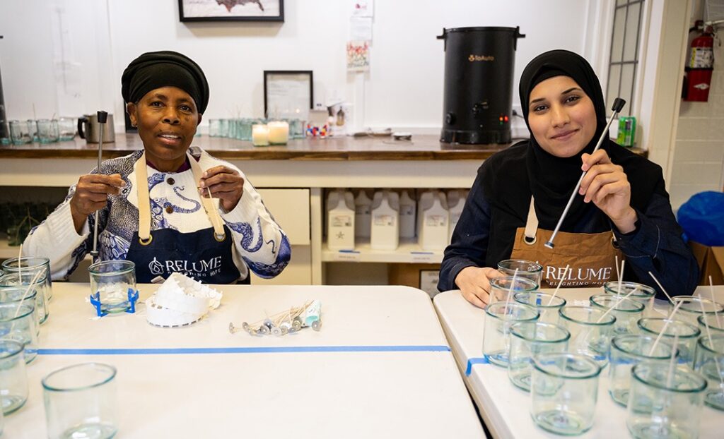 two women making candles together
