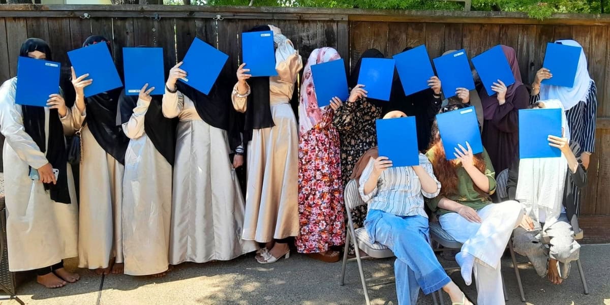 Graduates holding up their diplomas!