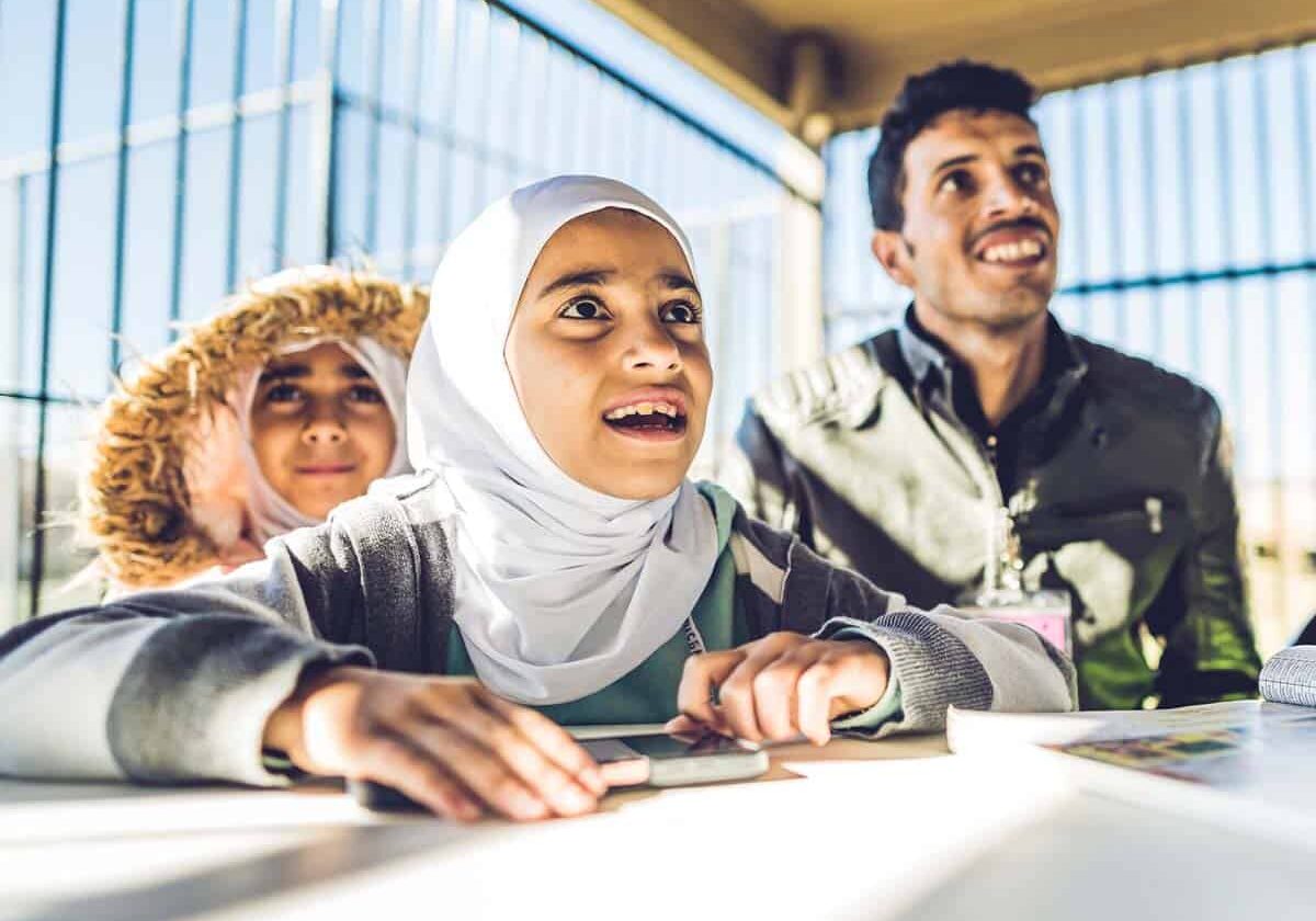 A father with his children participate in an ESL class with World Relief in Texas.