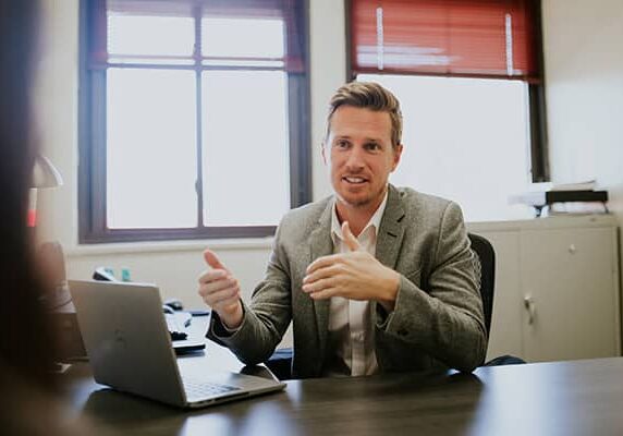 A World Relief lawyer converses with a person in his office